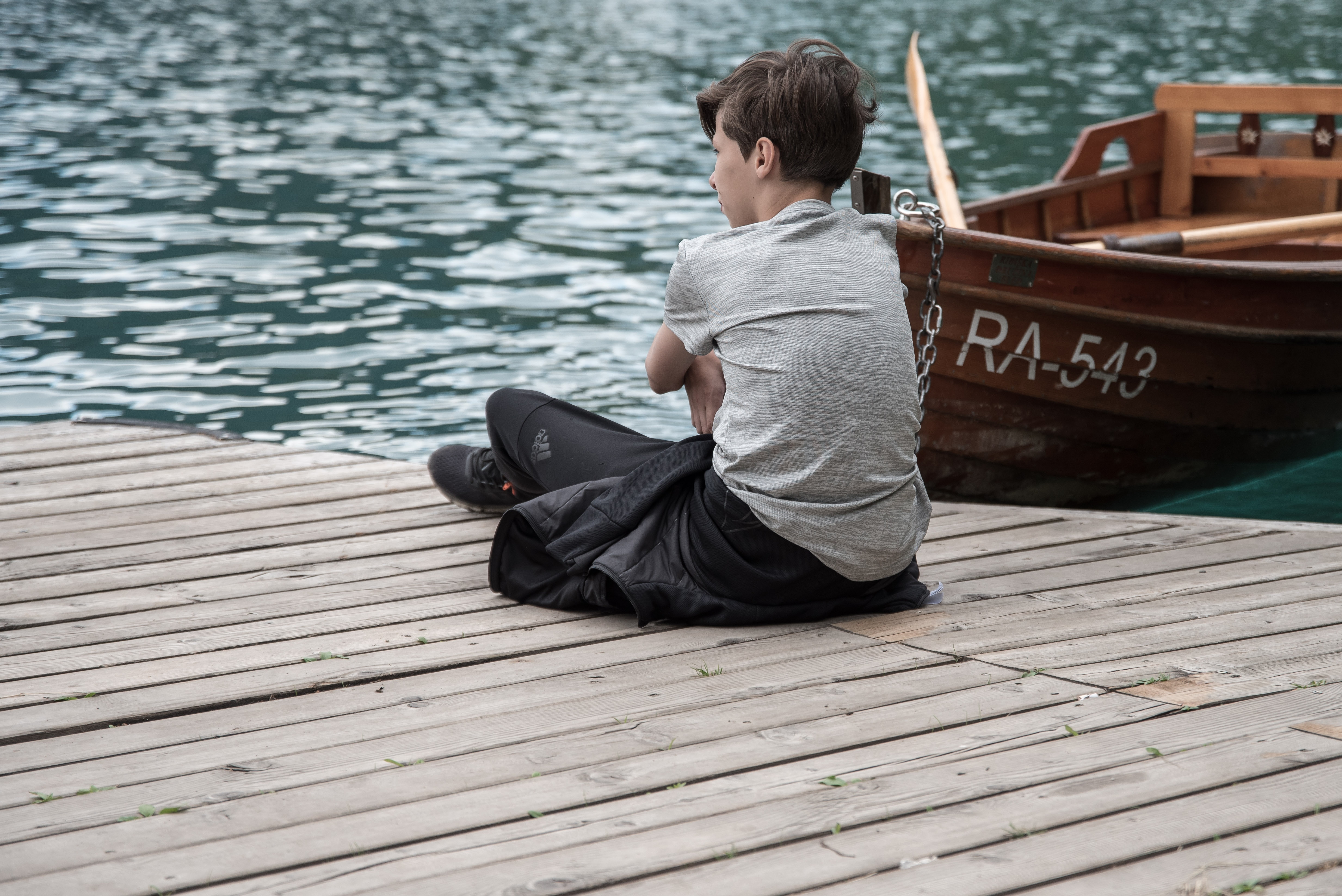 kid sitting on dock