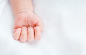 New born baby hand on white background
