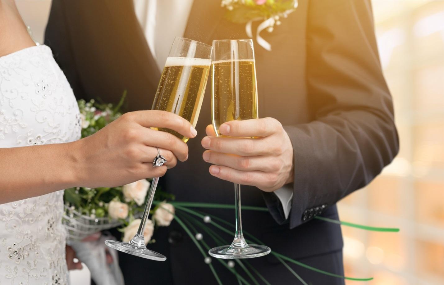 bride and groom holding champagne flutes at wedding celebration