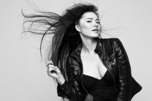 black and white photo of pretty woman with hair blowing in the wind