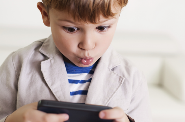 young boy using the internet on a mobile phone