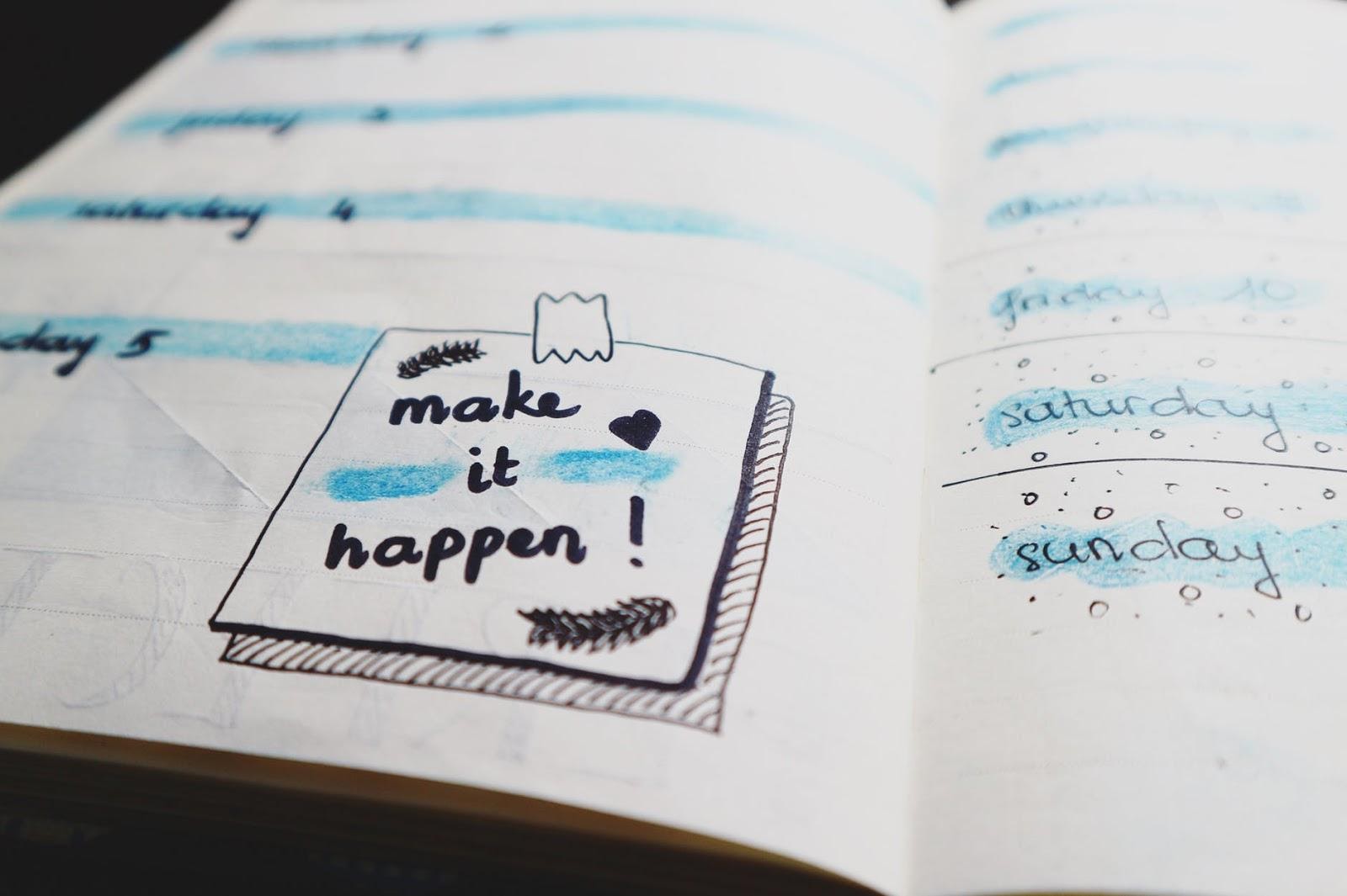 the words make it happen written on a notebook