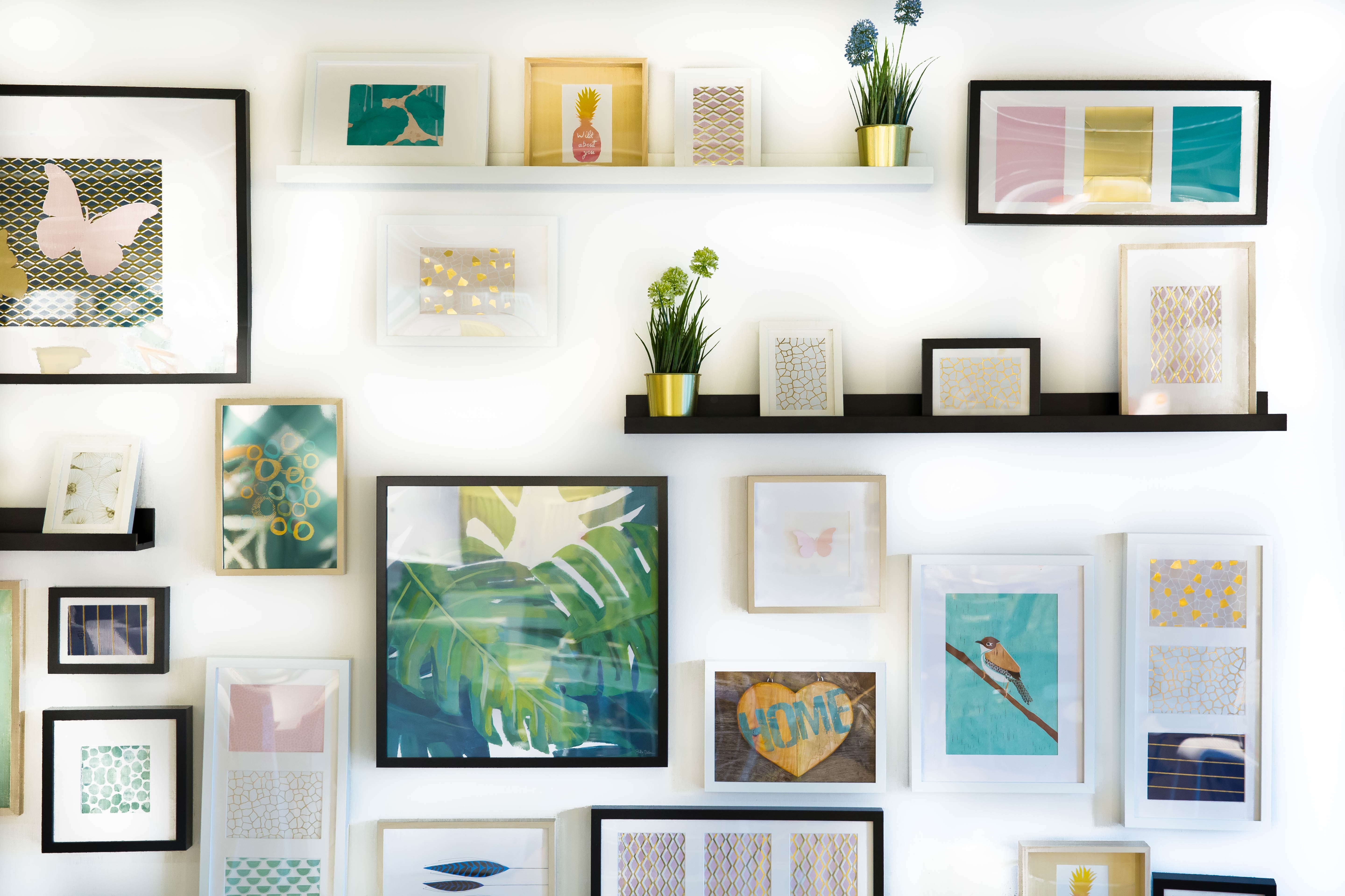 various pictures and frames on a white wall