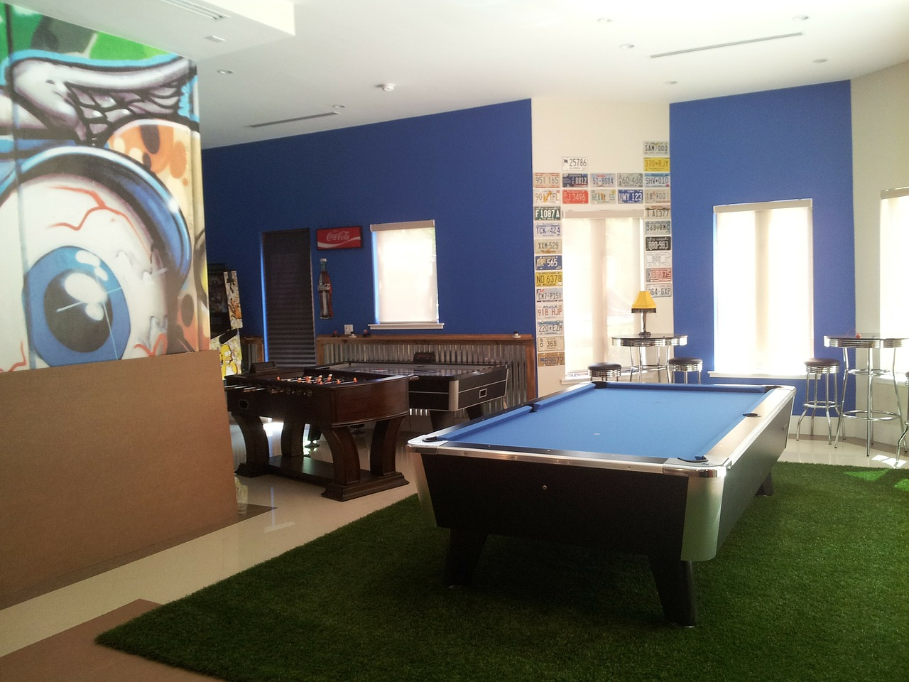 basement of house turned into game room with pool table and Foosball table